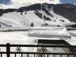 Winter view of Alpine ski area and pool from balcony